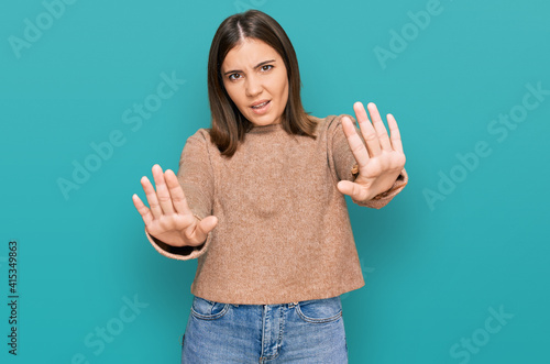 Young beautiful woman wearing casual clothes doing stop gesture with hands palms, angry and frustration expression