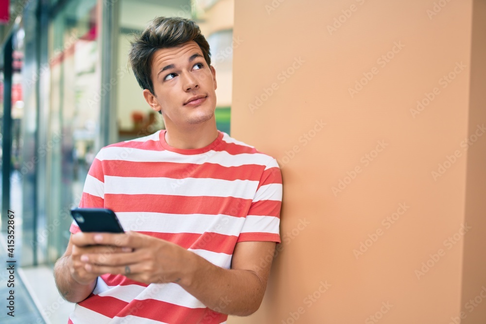 Young caucasian man thinking and using smartphone at the city. Young caucasian man thinking and using smartphone at the city.
