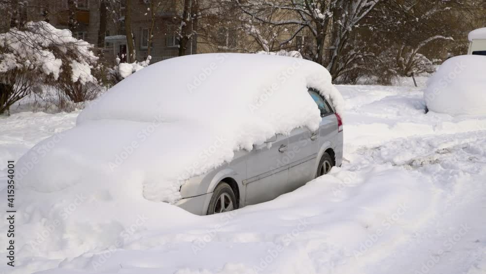 Car under thick blanket of snow after storm. Vehicles buried under ice. Nobody Car under thick blanket of snow after storm. Vehicles buried under ice. Nobody