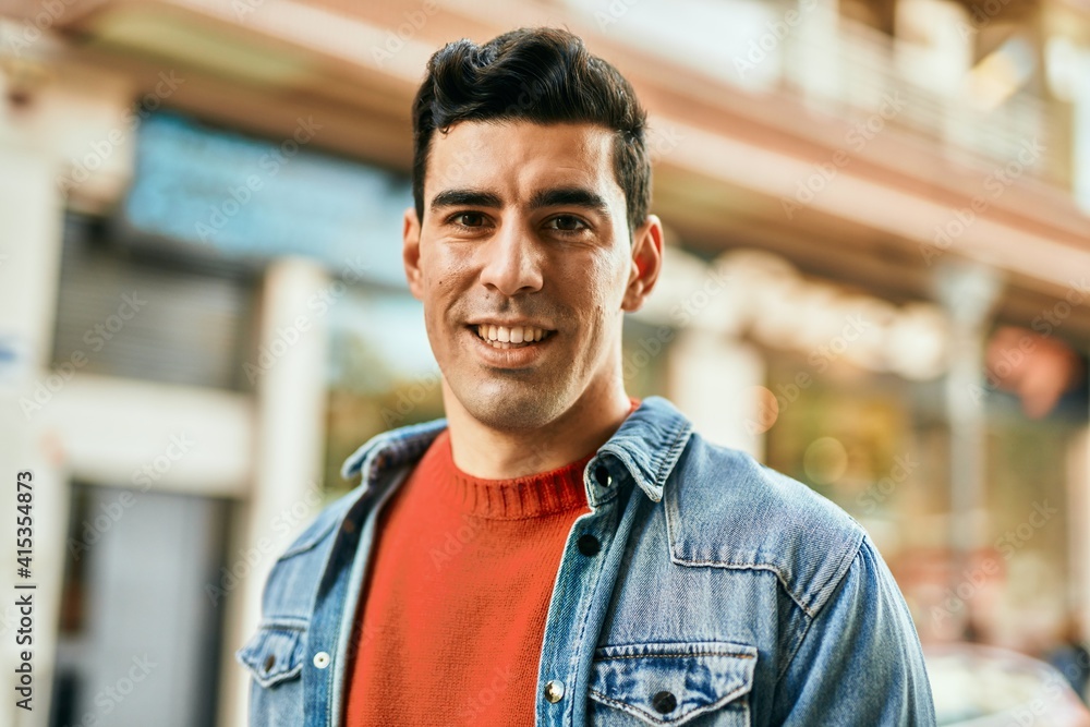 Young hispanic man smiling happy standing at the city. Young hispanic man smiling happy standing at the city.