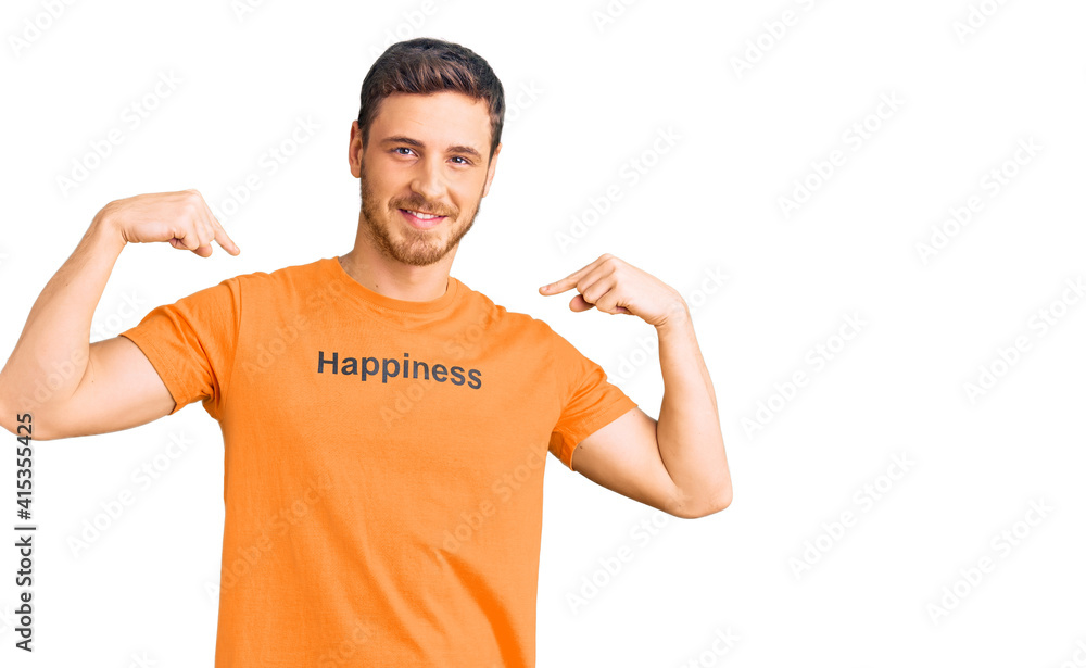 Handsome young man with bear wearing tshirt with happiness word message looking confident with smile on face, pointing oneself with fingers proud and happy. Handsome young man with bear wearing tshirt with happiness word message looking confident with smile on face, pointing oneself with fingers proud and happy.