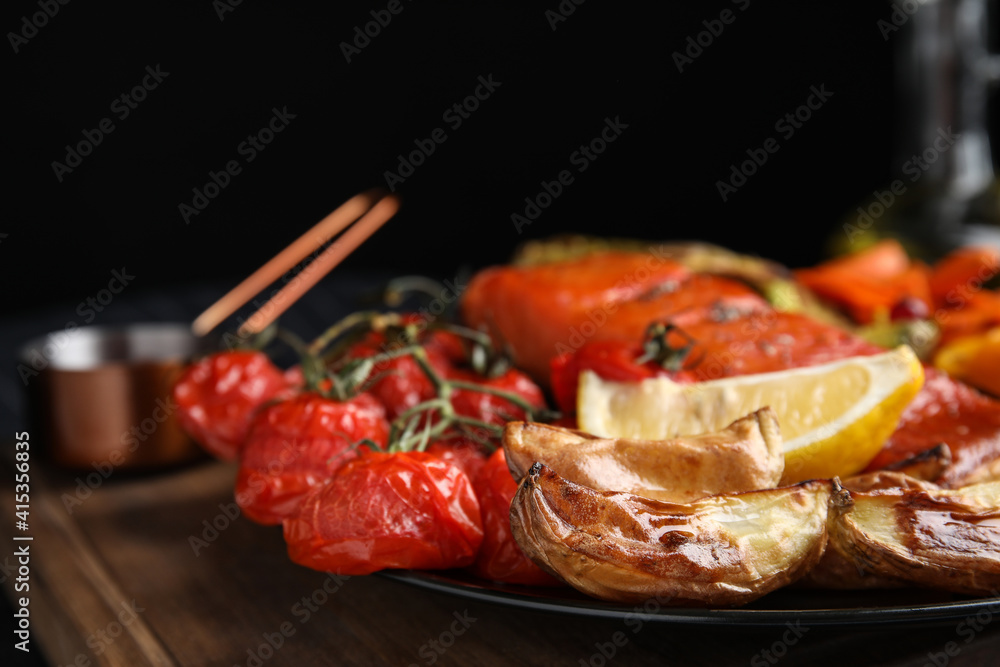 Tasty cooked salmon and vegetables served on table, closeup. Healthy meals from air fryer