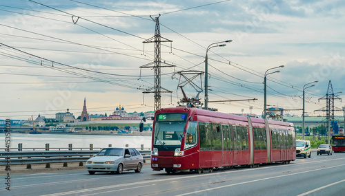 Red modern tram on the street in Kazan, Russia. Tram in front of the Kazan Kremlin. 