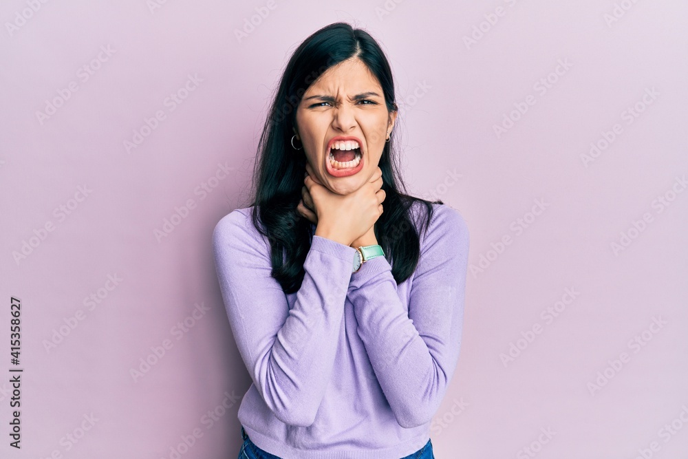 Young hispanic woman wearing casual clothes shouting suffocate because painful strangle. health problem. asphyxiate and suicide concept. Young hispanic woman wearing casual clothes shouting suffocate because painful strangle. health problem. asphyxiate and suicide concept.