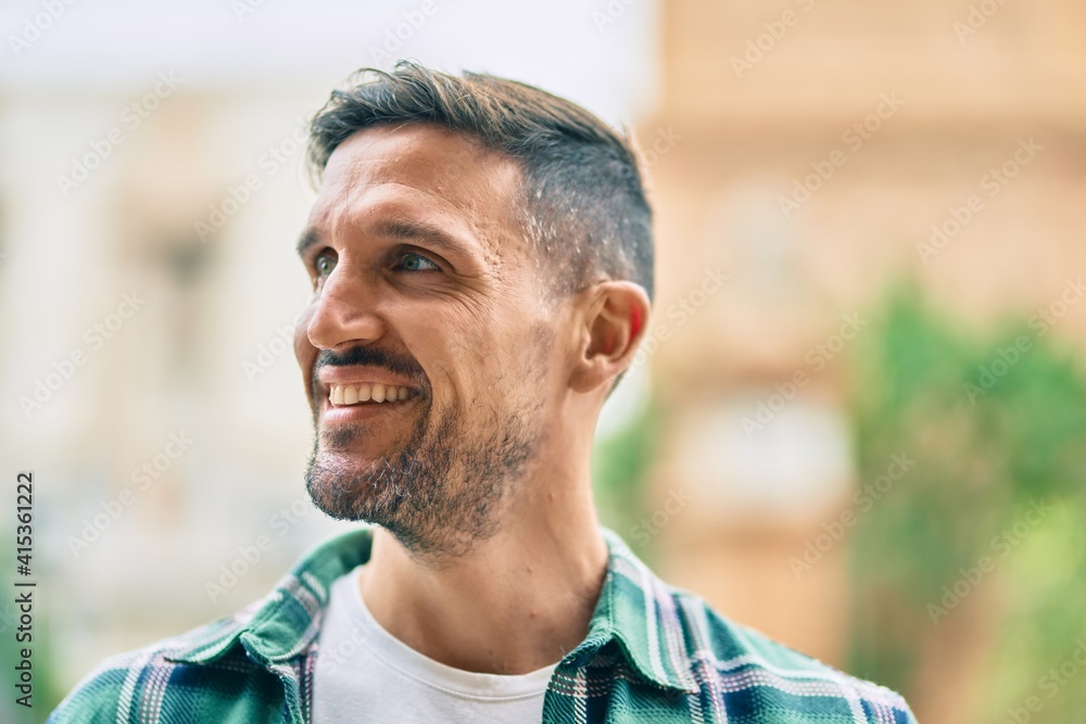 Young caucasian man smiling happy standing at the city. Young caucasian man smiling happy standing at the city.