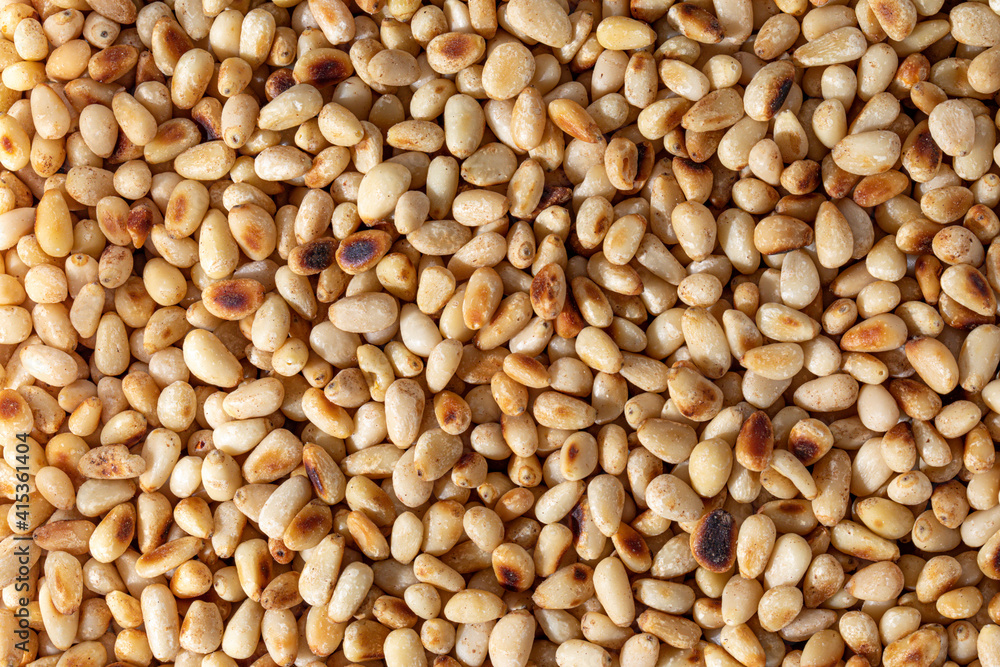 Full frame macro shot of ingredient roasted pine nuts. Full frame macro shot of ingredient roasted pine nuts.