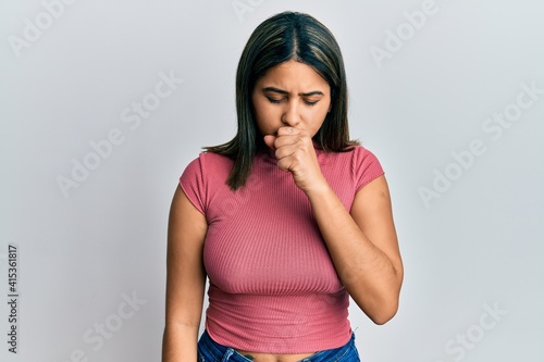 Tableau sur toile Young latin woman wearing casual clothes feeling unwell and coughing as symptom for cold or bronchitis