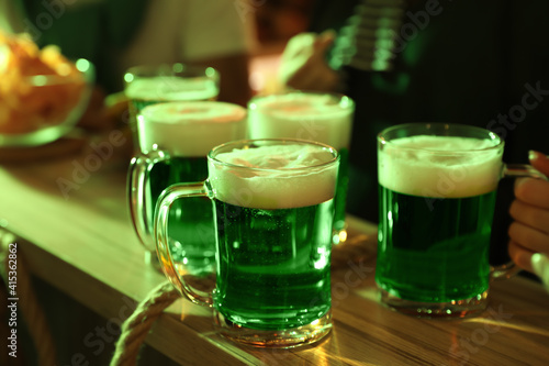 Fresh beer on wooden table in pub. St Patrick s day celebration