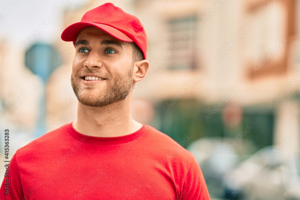 Young caucasian deliveryman smiling happy standing at the city. Young caucasian deliveryman smiling happy standing at the city.