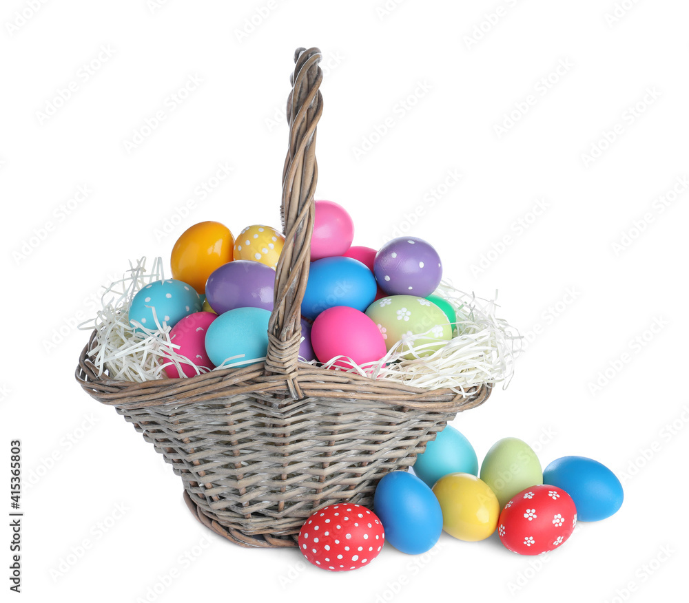 Wicker basket with bright painted Easter eggs on white background Wicker basket with bright painted Easter eggs on white background
