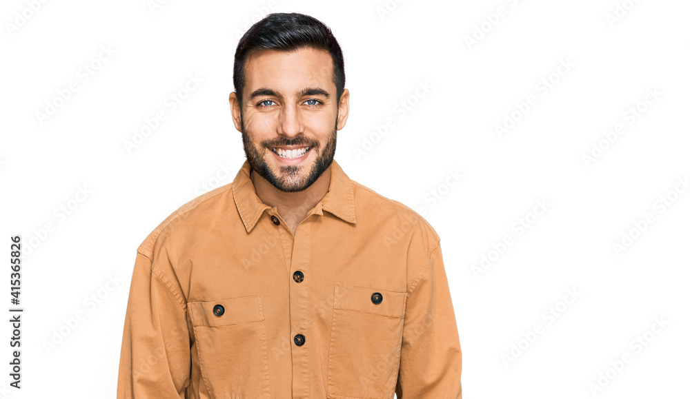Young hispanic man wearing casual clothes with a happy and cool smile on face. lucky person. Young hispanic man wearing casual clothes with a happy and cool smile on face. lucky person.