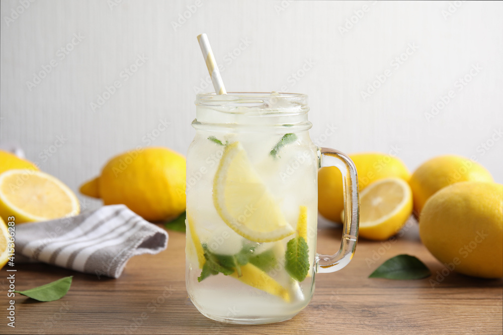 Mason jar of cold lemonade on wooden table Mason jar of cold lemonade on wooden table