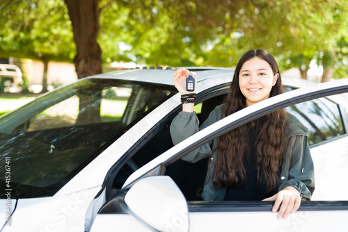 Beautiful teen girl holding the keys of her new car