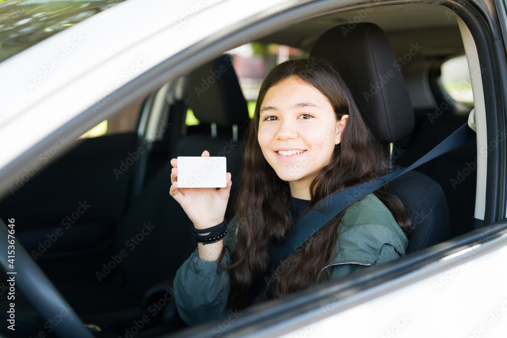 Cheerful teenage girl smiling after getting her driver's license