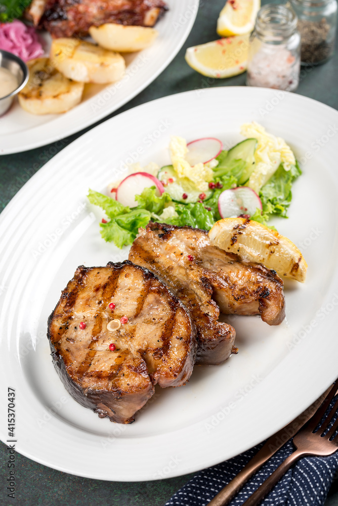 Grilled catfish steak with fresh herbs close up side view Grilled catfish steak with fresh herbs close up side view
