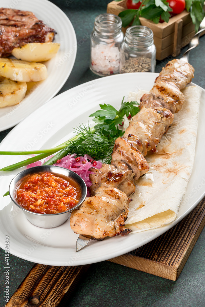 Chicken kebab with sauce and flatbread close-up Chicken kebab with sauce and flatbread close-up