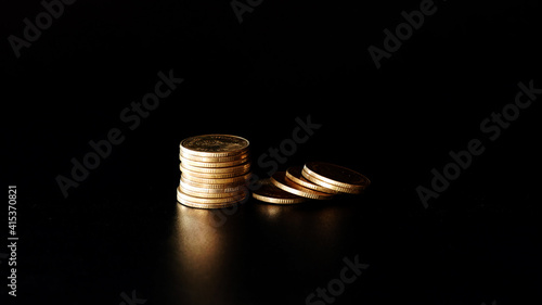 Wallpaper Mural stacks of gold coin on black background concept saving money Torontodigital.ca