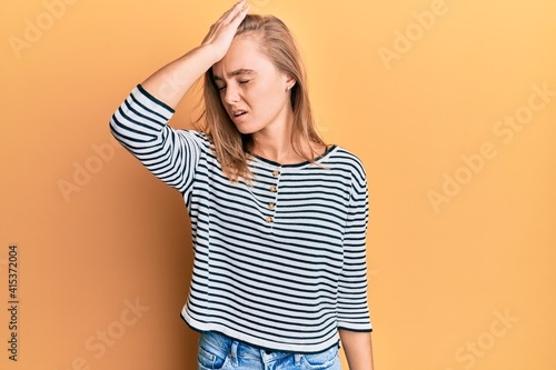Beautiful blonde woman wearing casual clothes surprised with hand on head for mistake, remember error. forgot, bad memory concept.