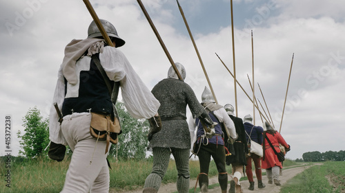 Bilde på lerret Back view of group medieval knights going on the battle.