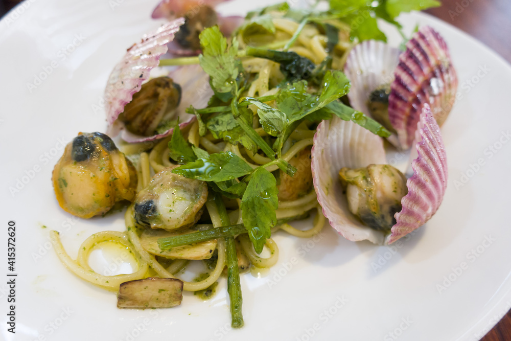 Spaghetti pasta Scallop and seafood in oil sauce with water parsley Spaghetti pasta Scallop and seafood in oil sauce with water parsley