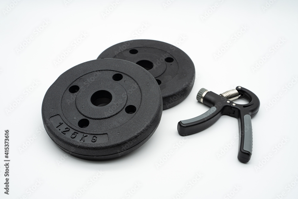 Concept image for healthy home training with grip and dumbbells Concept image for healthy home training with grip and dumbbells