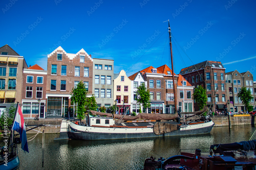 Rotterdam, Netherlands - July 5, 2019: Old houseboat in the canal of Delfshaven in Rotterdam