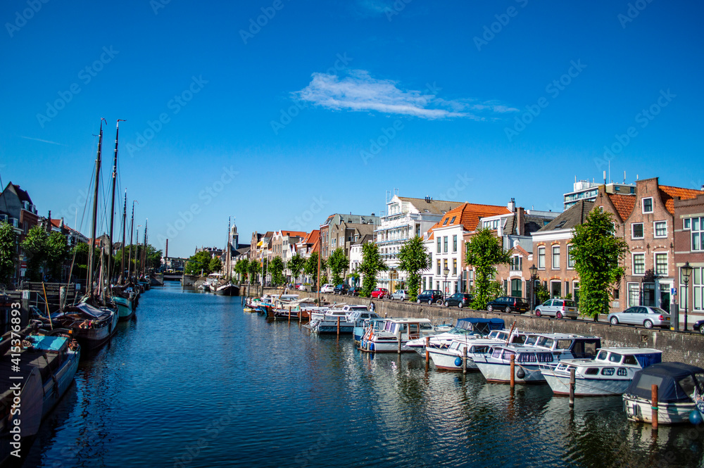 Rotterdam, Netherlands - July 5, 2019: Boats docked in the canal in Delfshaven district of Rotterdam