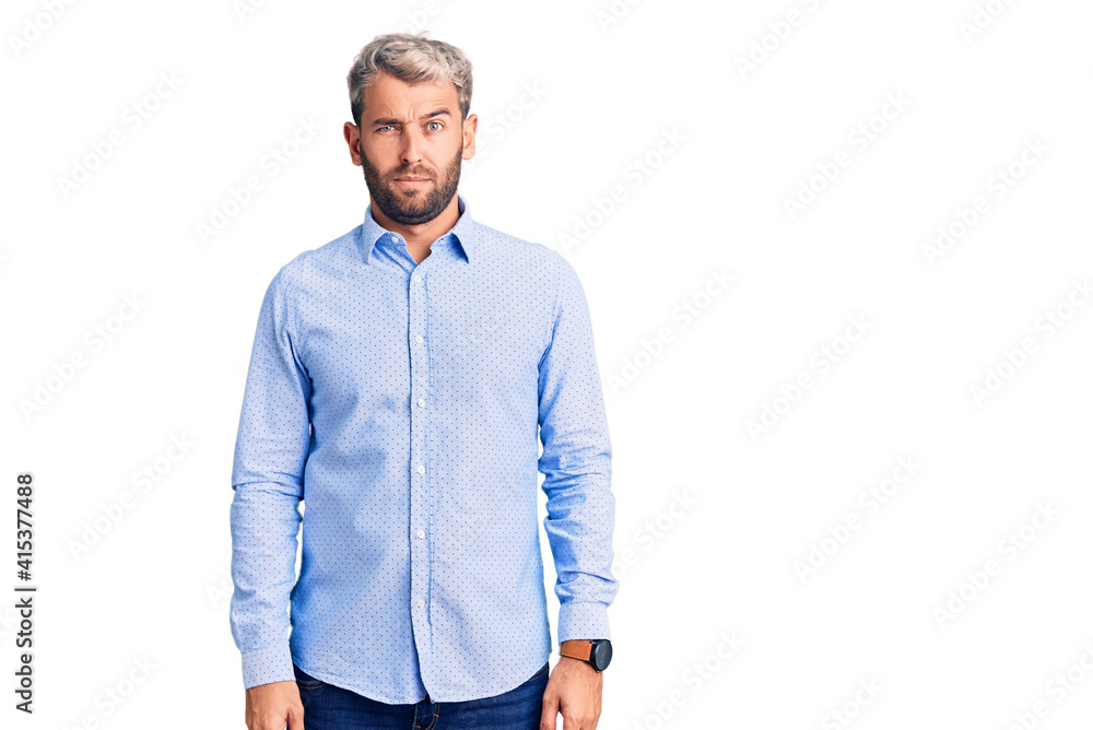 Young handsome blond man wearing elegant shirt skeptic and nervous, frowning upset because of problem. negative person. Young handsome blond man wearing elegant shirt skeptic and nervous, frowning upset because of problem. negative person.
