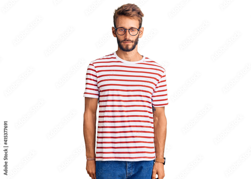 Fototapeta premium Handsome blond man with beard wearing casual clothes and glasses looking sleepy and tired, exhausted for fatigue and hangover, lazy eyes in the morning.