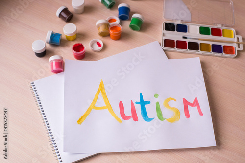 Creative design for april 2, autism world awareness day.  Painting word autism with paints photo