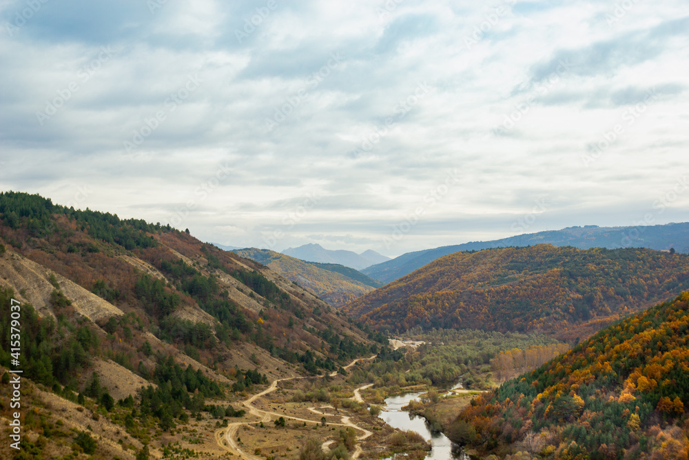 autumn in the mountains with river and sky
