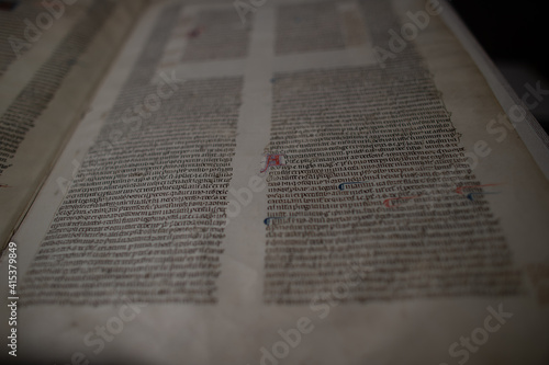 Medieval manuscript hand written on vellum with rubricated and illuminated initials, from a religious text from the C13th. 