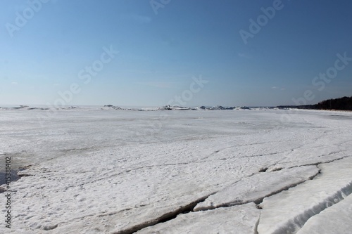 Hummocks on the shoals of the bay under the ice and snow
