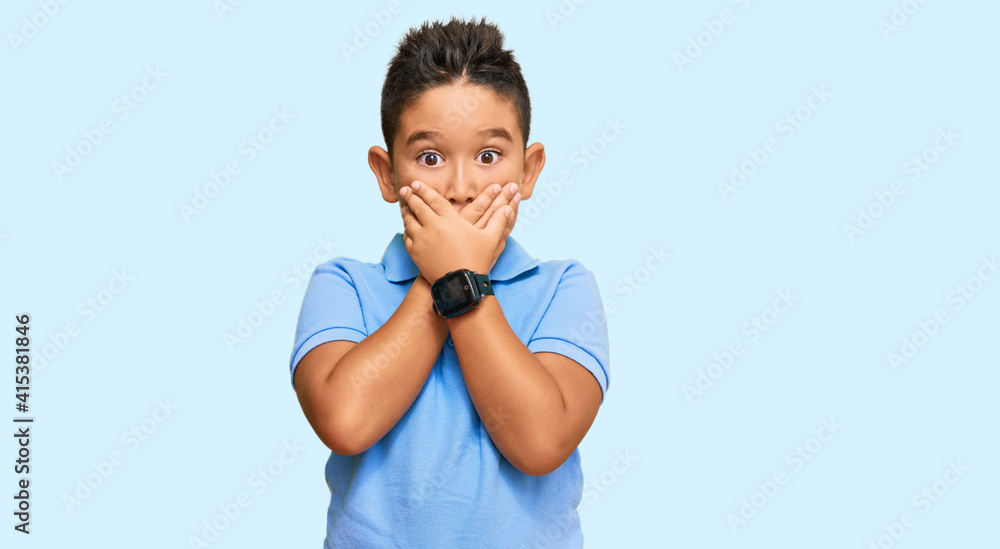 Little boy hispanic kid wearing casual clothes shocked covering mouth with hands for mistake. secret concept. Little boy hispanic kid wearing casual clothes shocked covering mouth with hands for mistake. secret concept.