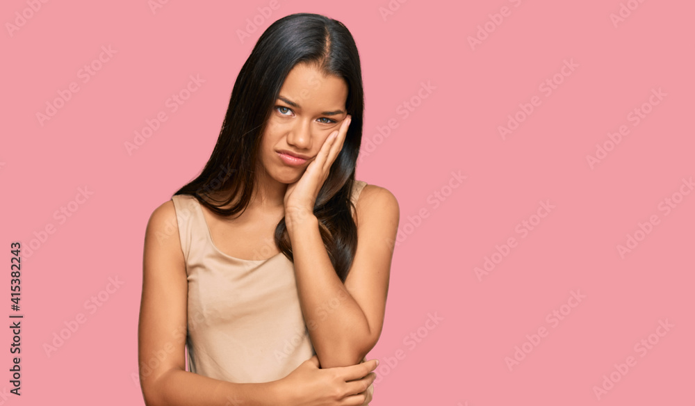 Beautiful hispanic woman wearing casual clothes thinking looking tired and bored with depression problems with crossed arms. Beautiful hispanic woman wearing casual clothes thinking looking tired and bored with depression problems with crossed arms.