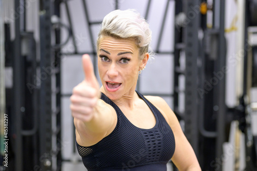 Positive healthy fit woman giving a thumbs up gesture