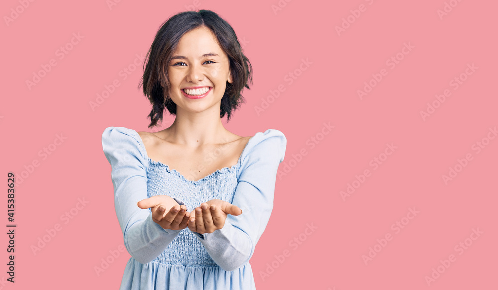 Young beautiful girl wearing casual clothes smiling with hands palms together receiving or giving gesture. hold and protection