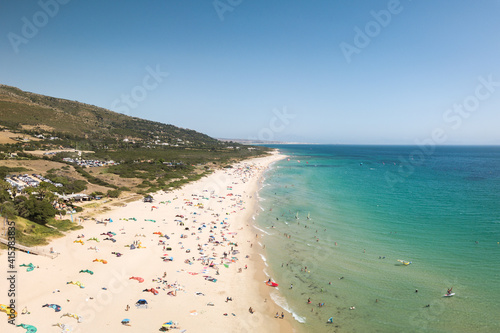 Drone perspective of wild beach situated in Tarifa , South of Spain.  Kitesurfing and wind surfing schools. Golden mile beach. Southern point of Europe