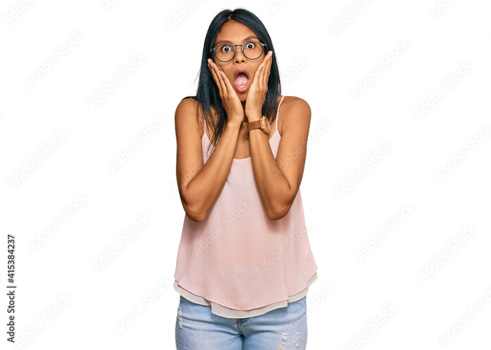 Young african american woman wearing casual clothes and glasses afraid and shocked, surprise and amazed expression with hands on face Young african american woman wearing casual clothes and glasses afraid and shocked, surprise and amazed expression with hands on face