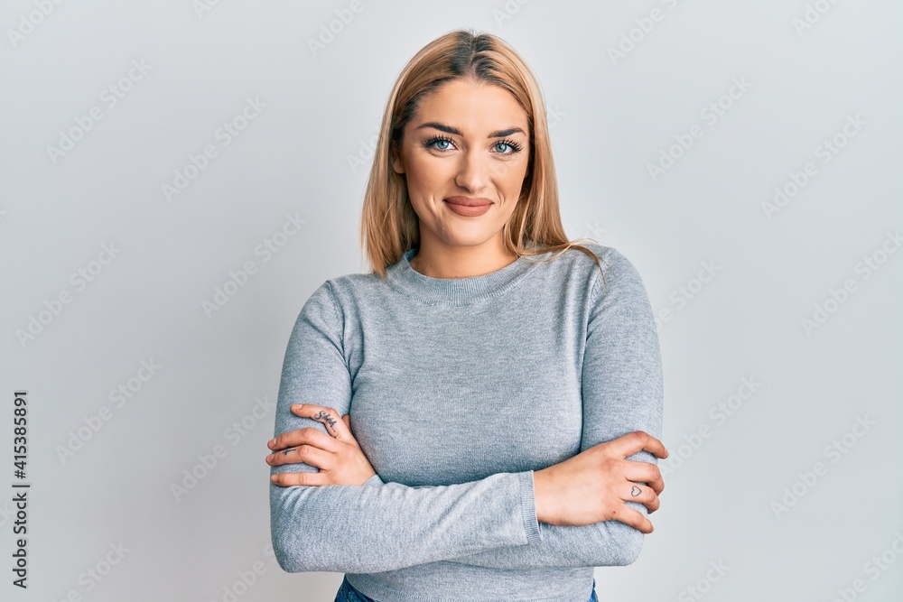 Young caucasian woman wearing casual clothes happy face smiling with crossed arms looking at the camera. positive person. Young caucasian woman wearing casual clothes happy face smiling with crossed arms looking at the camera. positive person.