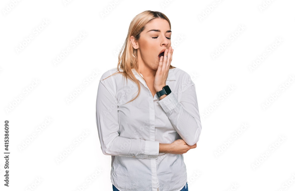 Young caucasian woman wearing casual clothes bored yawning tired covering mouth with hand. restless and sleepiness. Young caucasian woman wearing casual clothes bored yawning tired covering mouth with hand. restless and sleepiness.