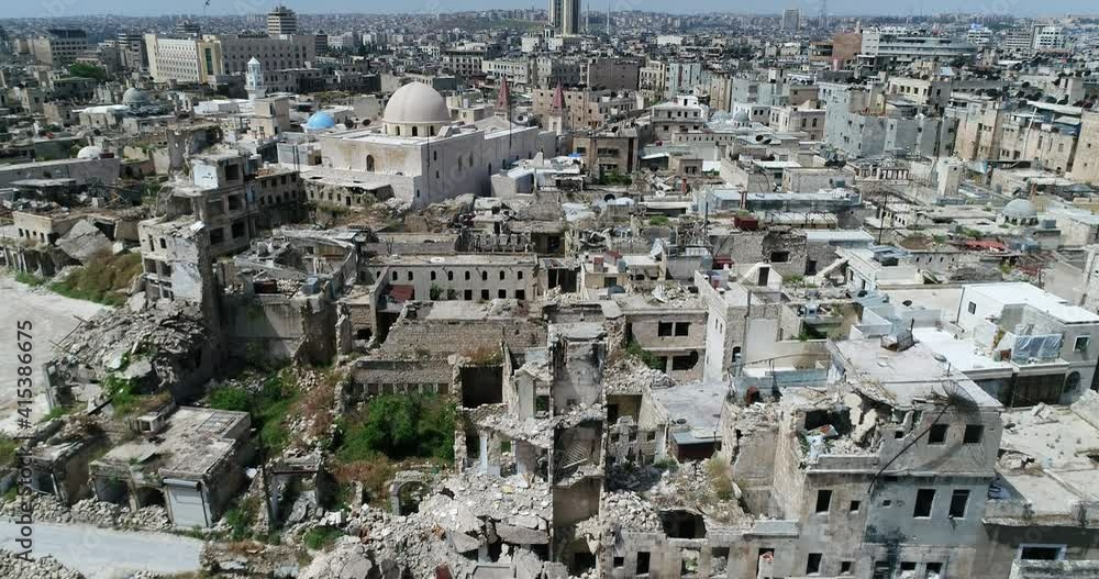Buildings of Aleppo in Syria 10 years after the civil war. We can see grass covering ruins of building, destroyed after bombing - aerial view 4K Buildings of Aleppo in Syria 10 years after the civil war. We can see grass covering ruins of building, destroyed after bombing - aerial view 4K
