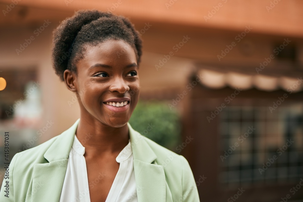 Young african american businesswoman smiling happy standing at the city Young african american businesswoman smiling happy standing at the city