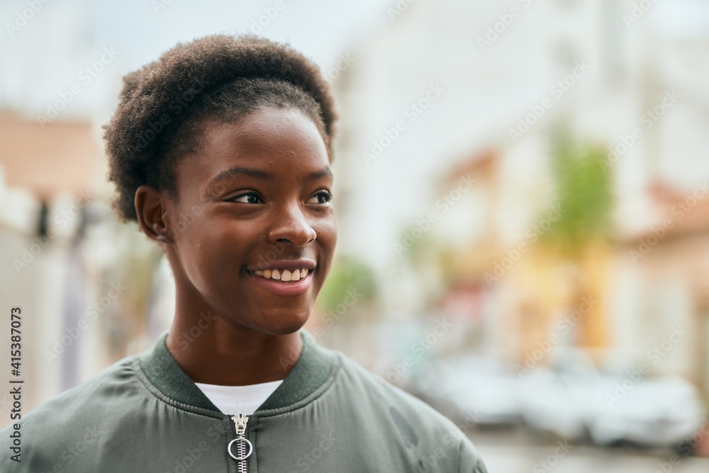 Young african american girl smiling happy standing at the city. Young african american girl smiling happy standing at the city.
