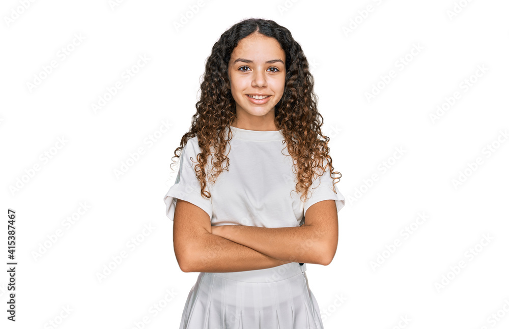 Teenager hispanic girl wearing casual white t shirt happy face smiling with crossed arms looking at the camera. positive person. Teenager hispanic girl wearing casual white t shirt happy face smiling with crossed arms looking at the camera. positive person.