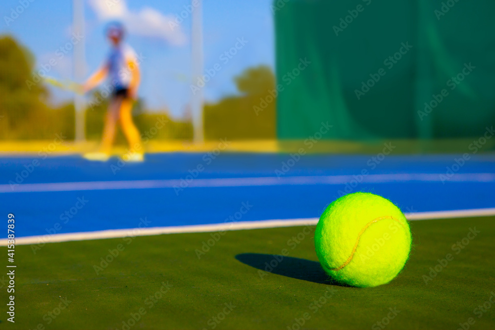 Tennis ball on the blue court