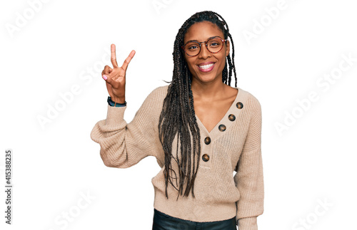 African american woman wearing casual clothes showing and pointing up with fingers number two while smiling confident and happy.