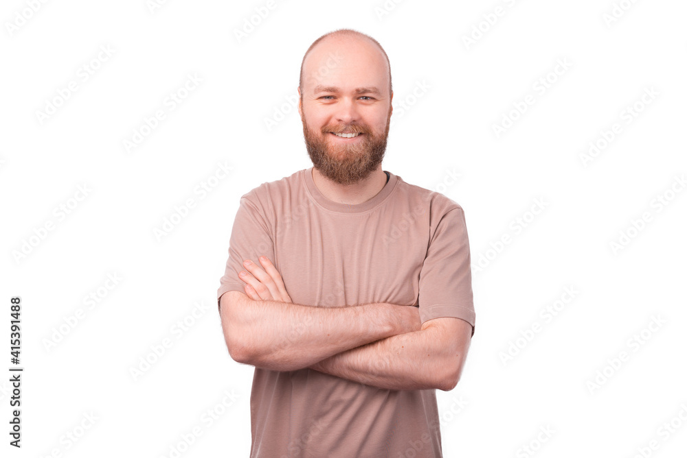 Smiling bearded hipster man standing over white background with crossed arms Smiling bearded hipster man standing over white background with crossed arms