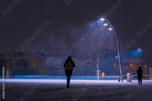 Photography Snow flurries on a square in the evening, street lights and snow flurries, it sn