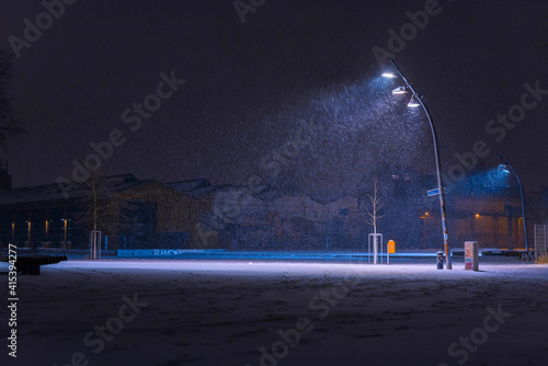 Photography Snow flurries on a square in the evening, street lights and snow flurries, it sn